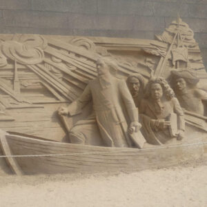 Stone carving of 4 men in small boat